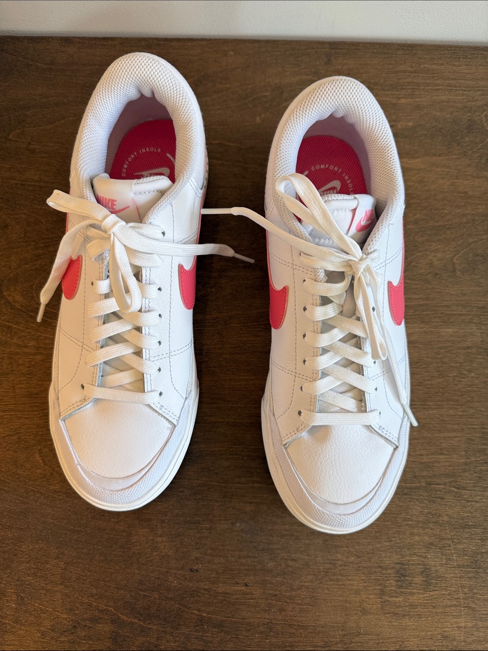Nike Women’s White Sneakers with Pink Swoosh Accents